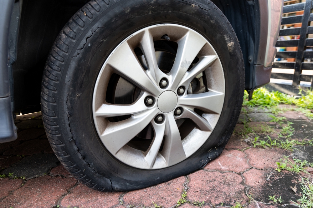 A damaged tire and bent rim caused by hitting a pothole