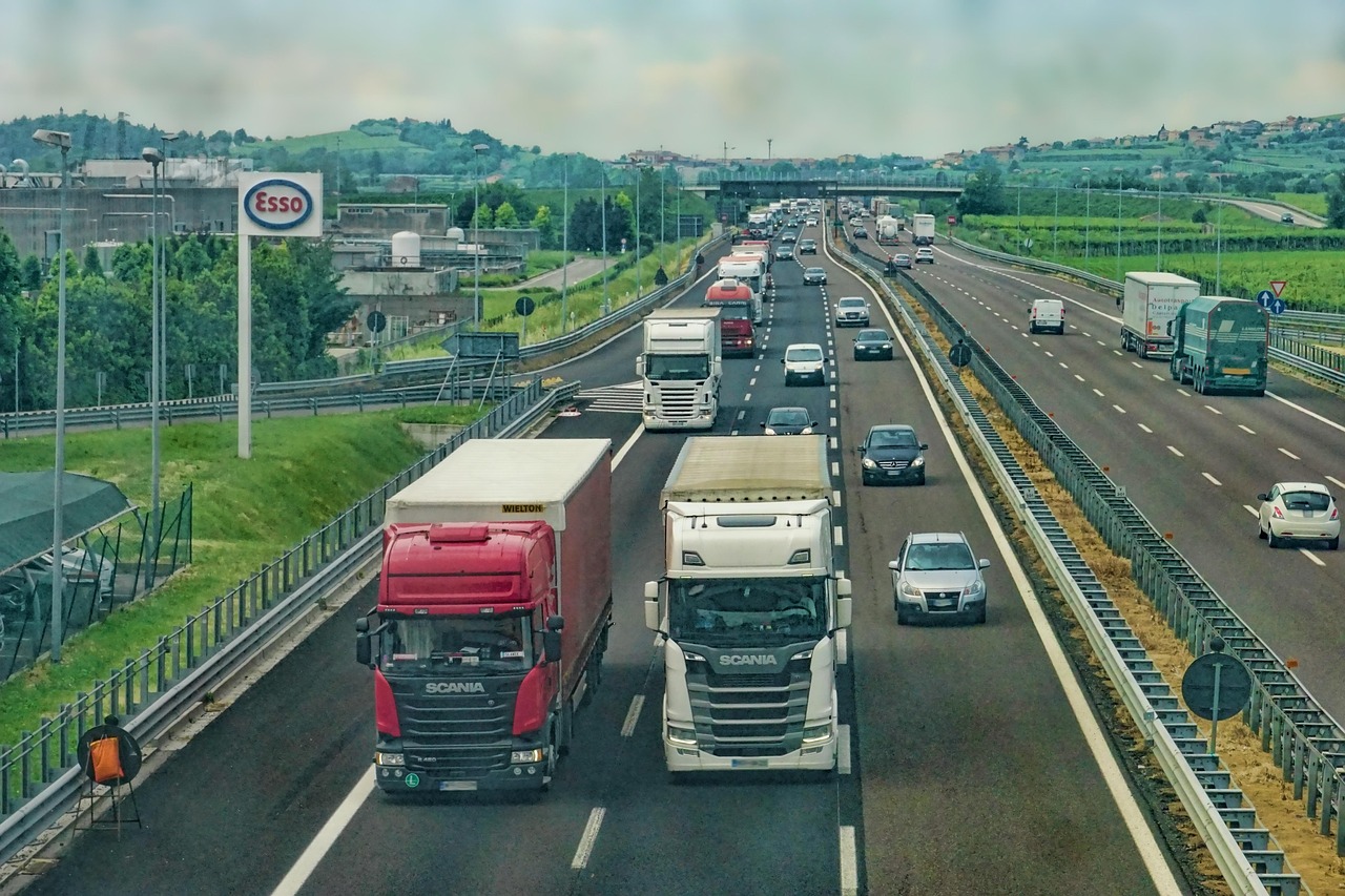 A busy highway with a mix of passenger vehicles and heavy commercial trucks